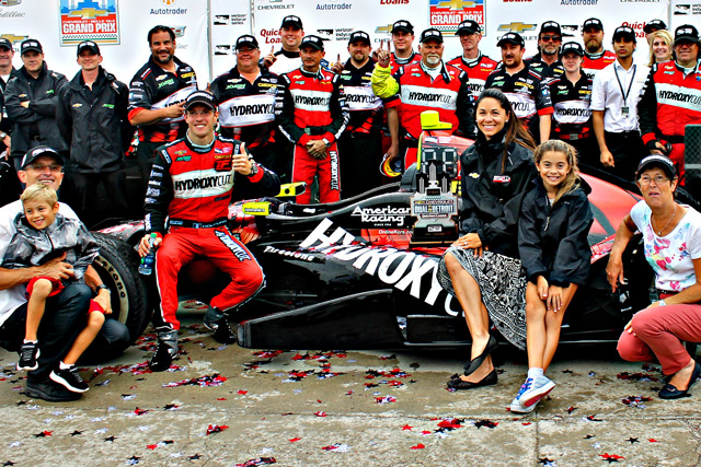 Sebastien celebrates in victory circle with his team and family after an INDYCAR win in Detroit